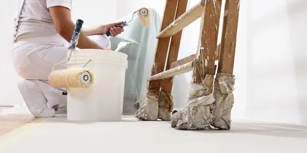 woman painting a clean white wall