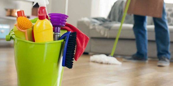 person quickly cleaning vinyl floors with green cleaning supplies